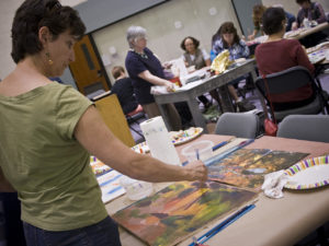 hurricane katrina exhibition with people painting landscape